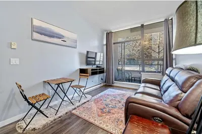 a living room with a couch and a table at Cozy 1 Bedroom Downtown Central in Vancouver