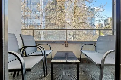a group of chairs and a table on a balcony at Cozy 1 Bedroom Downtown Central in Vancouver