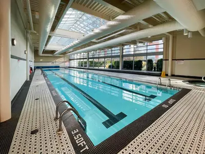 a large swimming pool in a large building at Condo Downtown Vancouver - Near Rogers Arena & BC Place w Parking in Vancouver