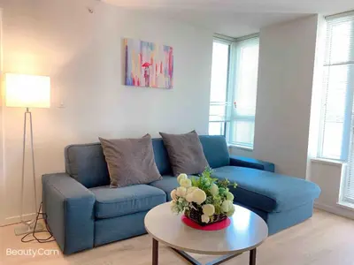a living room with a blue couch and a table at Cozy Perfect &elegant 2bed 1 bath in Richmond center in Richmond