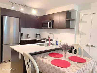 a kitchen with a table with red plates on it at Cozy Perfect &elegant 2bed 1 bath in Richmond center in Richmond