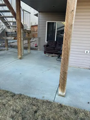a patio with a couch on the side of a house at Unique home services in Bélanger