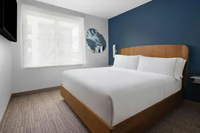 a large white bed in a room with a window at Element Calgary Downtown by Westin in Calgary