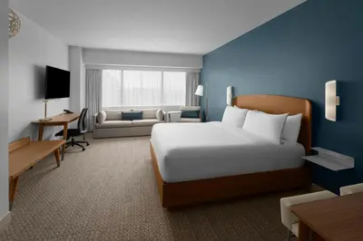a hotel room with a large bed and a couch at Element Calgary Downtown by Westin in Calgary