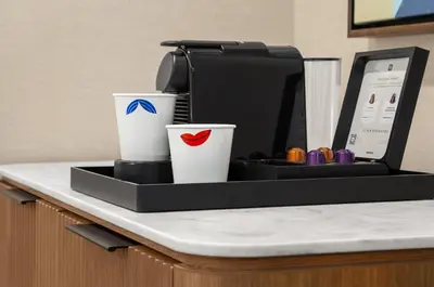 a coffee maker and two cups on a counter at Hampton Inn By Hilton Calgary Downtown in Calgary