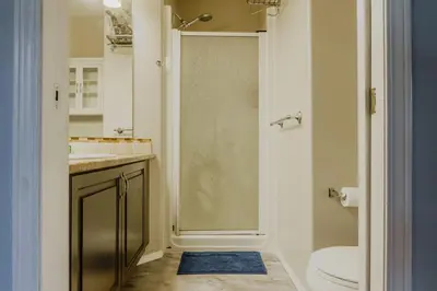 a bathroom with a shower with a toilet and a sink at entire house THE BLUE DOOR with garage access in Grande Prairie