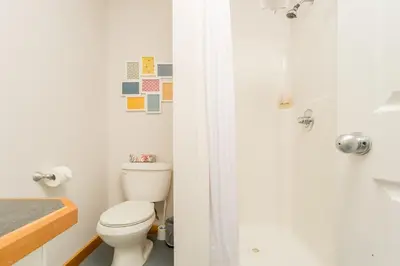 a bathroom with a toilet and a shower at Pet Friendly 3 Bdrm Home with Hot Tub by StayIn in Fernie