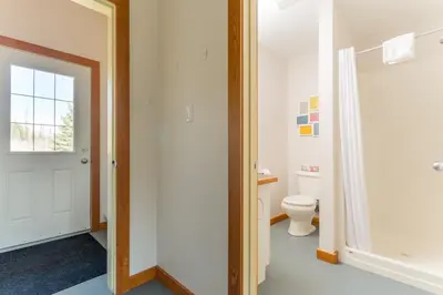 a bathroom with a toilet and a window at Pet Friendly 3 Bdrm Home with Hot Tub by StayIn in Fernie