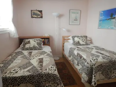 a bedroom with two beds and a book shelf at Clean and Quiet 2 bdr 2 bthr private entrance entire guests suite near Coquitlam Center mall and skytrain in Coquitlam