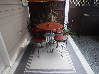 a small table and chairs sitting on a patio at Clean and Quiet 2 bdr 2 bthr private entrance entire guests suite near Coquitlam Center mall and skytrain in Coquitlam