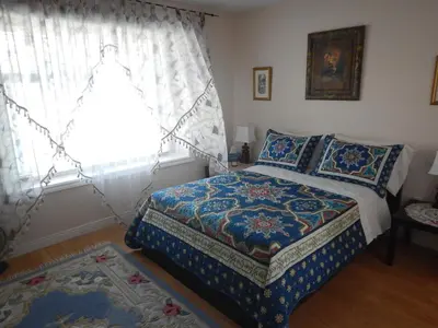 a bedroom with a bed and a window at Clean and Quiet 2 bdr 2 bthr private entrance entire guests suite near Coquitlam Center mall and skytrain in Coquitlam