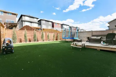 a backyard with a green yard with a playground at Little Nest in Calgary