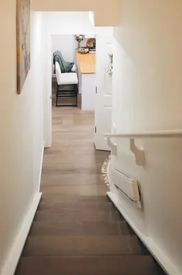 a hallway leading to a kitchen with a table at Little Nest in Calgary