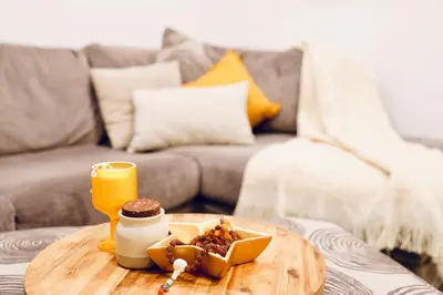 a coffee table with a plate of food on a couch at Little Nest in Calgary