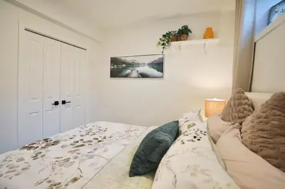 a bedroom with a bed with a blanket at Little Nest in Calgary