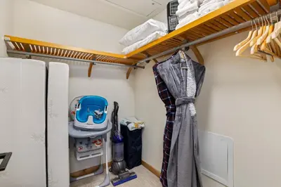 a room with a closet with a clothes rack at Spring Creek Corner Condo by Canadian Rockies Vacation Rentals in Canmore