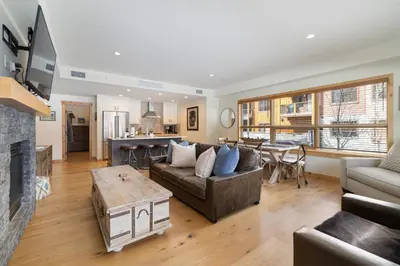 a living room with a couch and a fireplace at Spring Creek Corner Condo by Canadian Rockies Vacation Rentals in Canmore