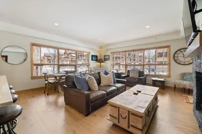 a living room with a couch and a table at Spring Creek Corner Condo by Canadian Rockies Vacation Rentals in Canmore