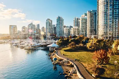 a view of a city with boats in the water at The Como Hotel in Vancouver