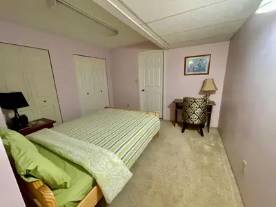 a bedroom with a bed and a table with a lamp at Imperial Ranchettes GuestSuite in Lone Butte