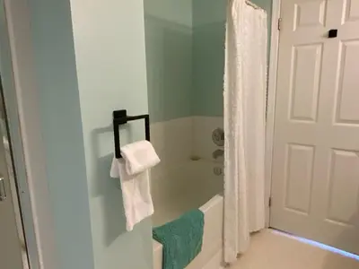 a bathroom with a tub and a shower with a towel at Imperial Ranchettes GuestSuite in Lone Butte