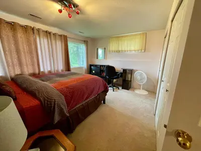 a bedroom with a bed and a desk and a window at Imperial Ranchettes GuestSuite in Lone Butte