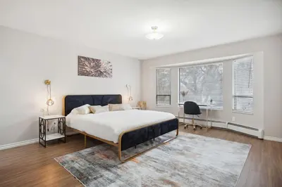 a bedroom with a bed and a desk in it at 6 Bedroom Family Home with Indoor Arcade, BBQ, Huge Backyard & Pickleball in Vancouver