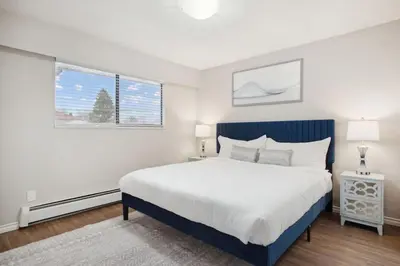 a bedroom with a large bed and a window at 6 Bedroom Family Home with Indoor Arcade, BBQ, Huge Backyard & Pickleball in Vancouver