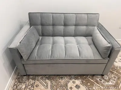 a grey couch in a room with a rug at Home sweet home in Calgary