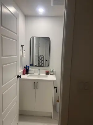 a bathroom with a white sink and a mirror at Home sweet home in Calgary