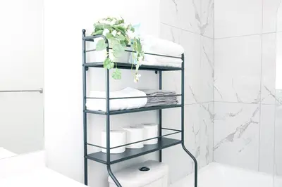 a black towel rack in a bathroom with towels at Comfy & Modern 2 Bedroom Guest Suite with King Bed in Edmonton