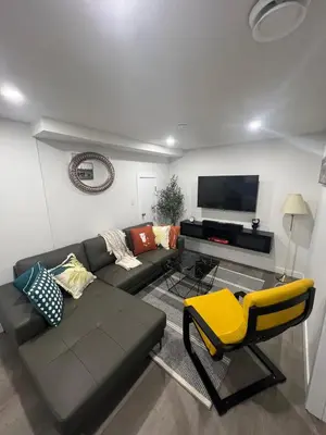 a living room with a couch and a tv at Comfy & Modern 2 Bedroom Guest Suite with King Bed in Edmonton
