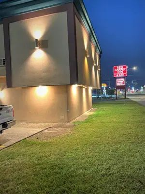 a building with lights on the side of it at Red Carpet Inn & Suites in Calgary
