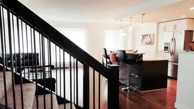 a kitchen with a staircase and a kitchen with a table at Discover Tranquility in this 2 bed townhouse in Vancouver