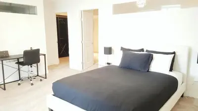 a bedroom with a bed and a desk in it at Discover Tranquility in this 2 bed townhouse in Vancouver