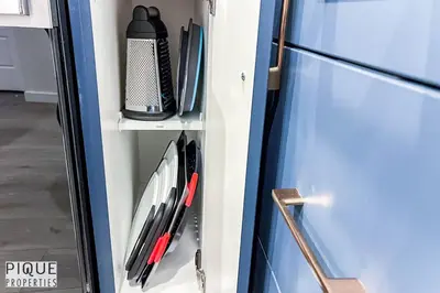 a refrigerator with some utensils on a shelf at NEW-The Suite Life-2BD-King Bed-WEM & YEG Airport in Edmonton