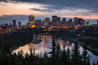 a city skyline with a river and a city at NEW-The Suite Life-2BD-King Bed-WEM & YEG Airport in Edmonton