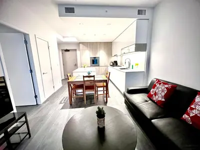 a living room with a couch and a table at Exquisite 1bed 1 bath locates in city center in Richmond
