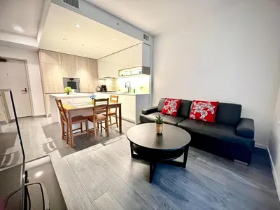 a living room with a couch and a table at Exquisite 1bed 1 bath locates in city center in Richmond