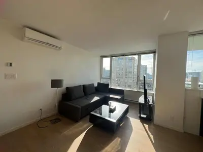 a living room with a couch and a table at Elegant &comfortable room1B &1B apartment perfect location in Richmond