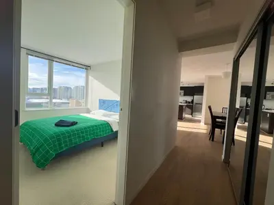 a bedroom with a bed with a green blanket at Elegant &comfortable room1B &1B apartment perfect location in Richmond