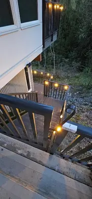 a bench sitting outside of a house with lights on it at Casa del Rio - Peaceful River Guest Suite -Forests -Mountains -Hiking in Chilliwack