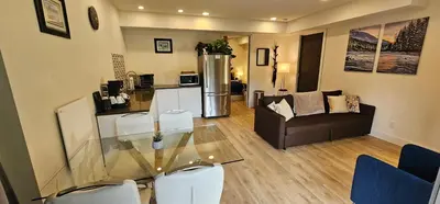 a living room with a glass table and a couch at Casa del Rio - Peaceful River Guest Suite -Forests -Mountains -Hiking in Chilliwack