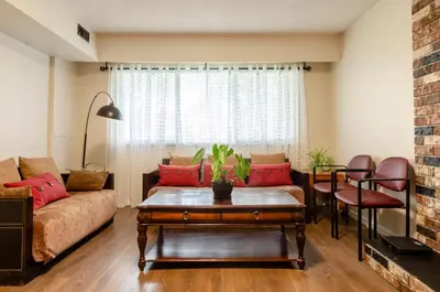 a living room with a couch and a table at Close to YVR! Convenient 3BR Stay for Every Occasion in Vancouver
