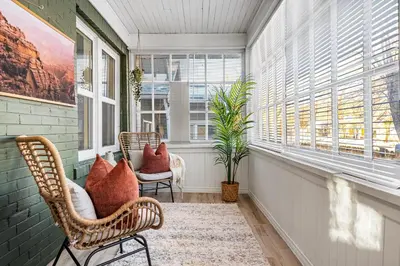 a room with two chairs and two windows at The Sandlot Family in Drumheller