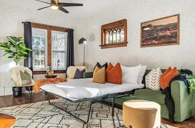a living room with a bed and a couch at The Sandlot Family in Drumheller