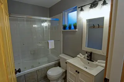 a bathroom with a toilet and a shower and a sink at Tide and Trail- Cabin in Ucluelet in Ucluelet