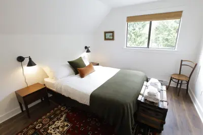 a bedroom with a large bed with a window at Raven Lady #201- Ucluelet Sleeps 6 Pet Friendly in Ucluelet