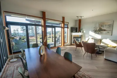 a living room with a wooden table and chairs at Big Beach Escape - Ucluelet - Sleeps 6 - Pet Friendly in Ucluelet