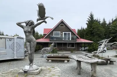 a statue of a woman with an eagle and a house at Raven Lady #202- Ucluelet, Sleeps 4, Pet Friendly in Ucluelet